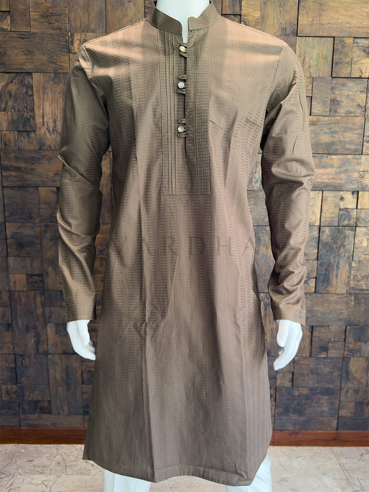 Brown kurta on a mannequin against a wooden paneled wall. This garment features a highly sophisticated, all-over woven vertical micro-stripe or dobby texture. This tactile pattern gives the fabric a premium, slightly heavyweight appearance, subtly elongating the wearer&