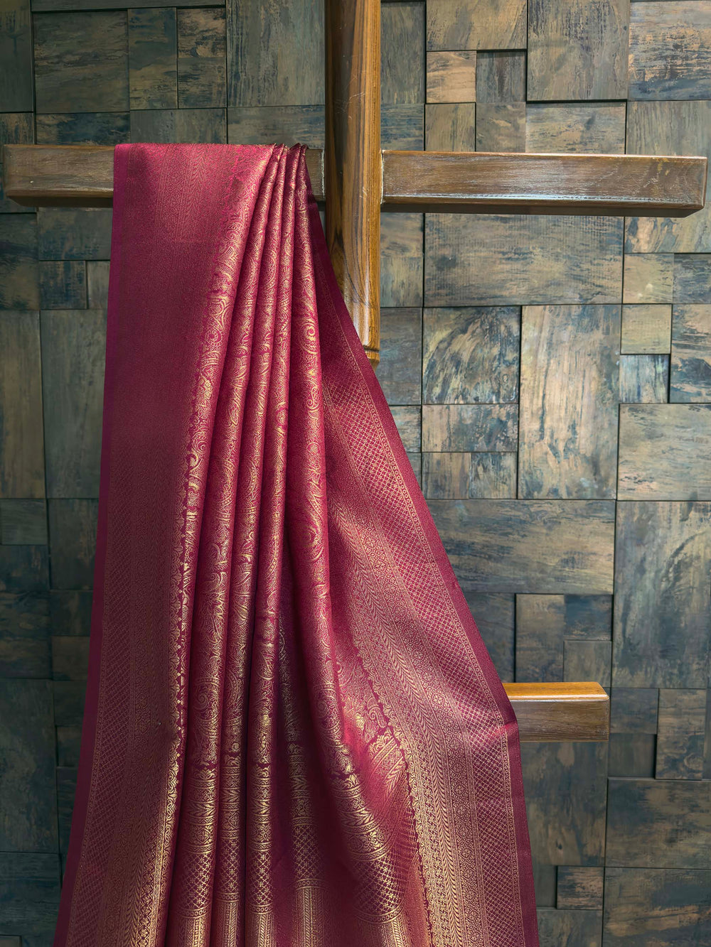 Close-up of the heavy brocade blouse fabric showing dense diamond gold zari weave.