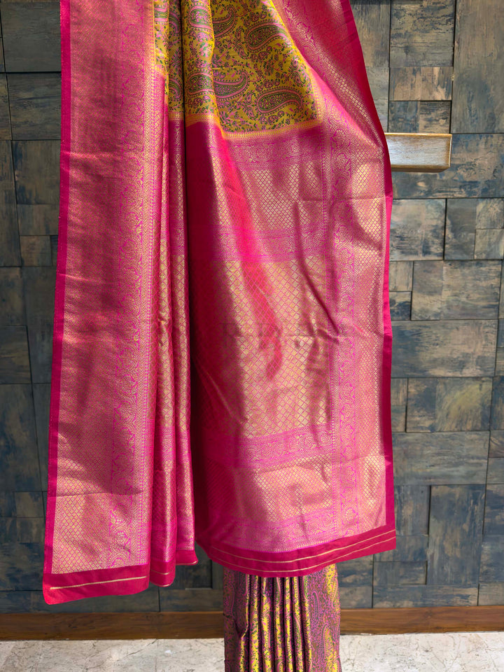 Detail shot of the Hot Pink Gold Zari border contrasting with the yellow body.