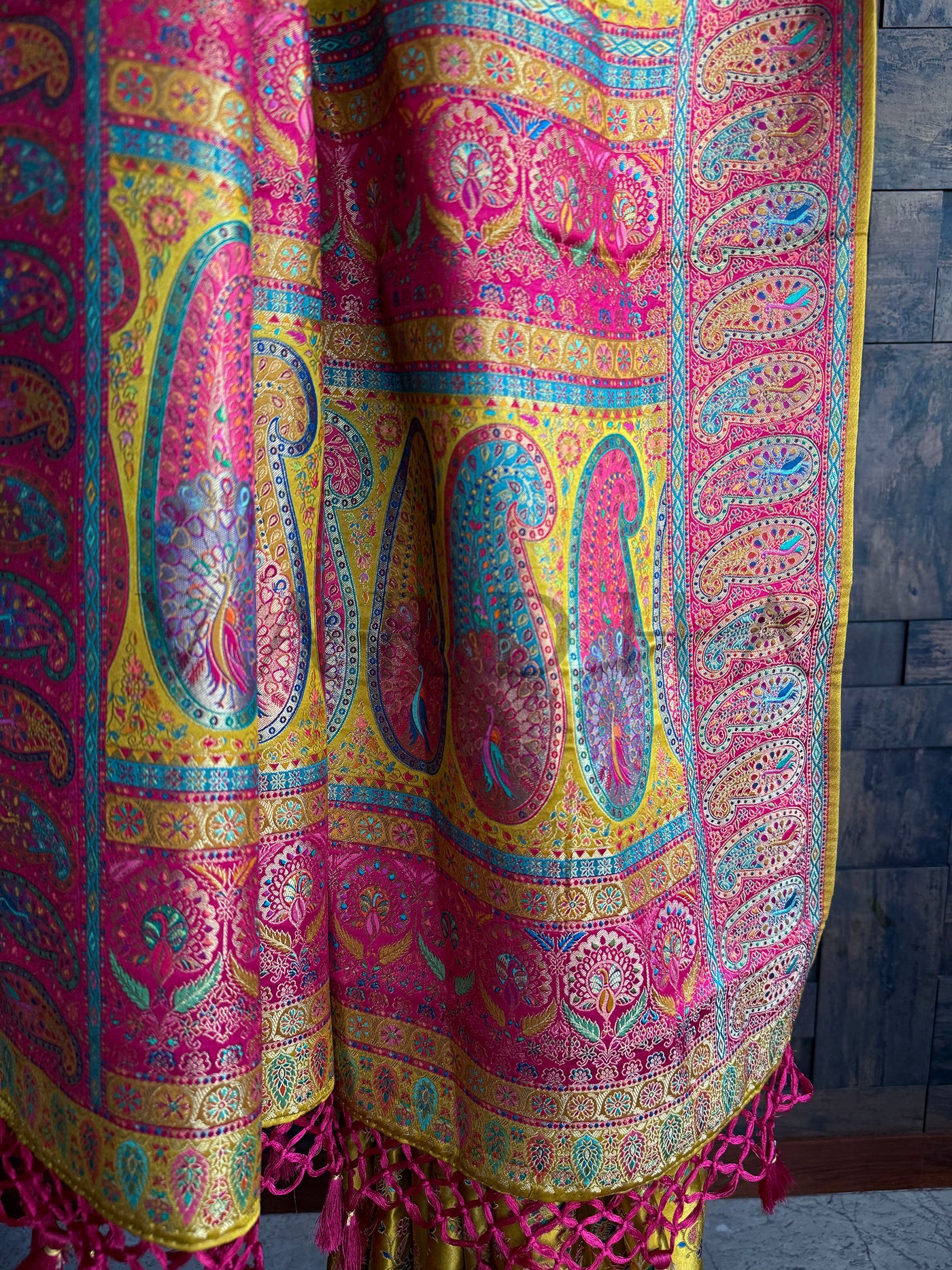 Woven brocade pallu with bold paisley motifs in fuchsia, teal, and antique gold