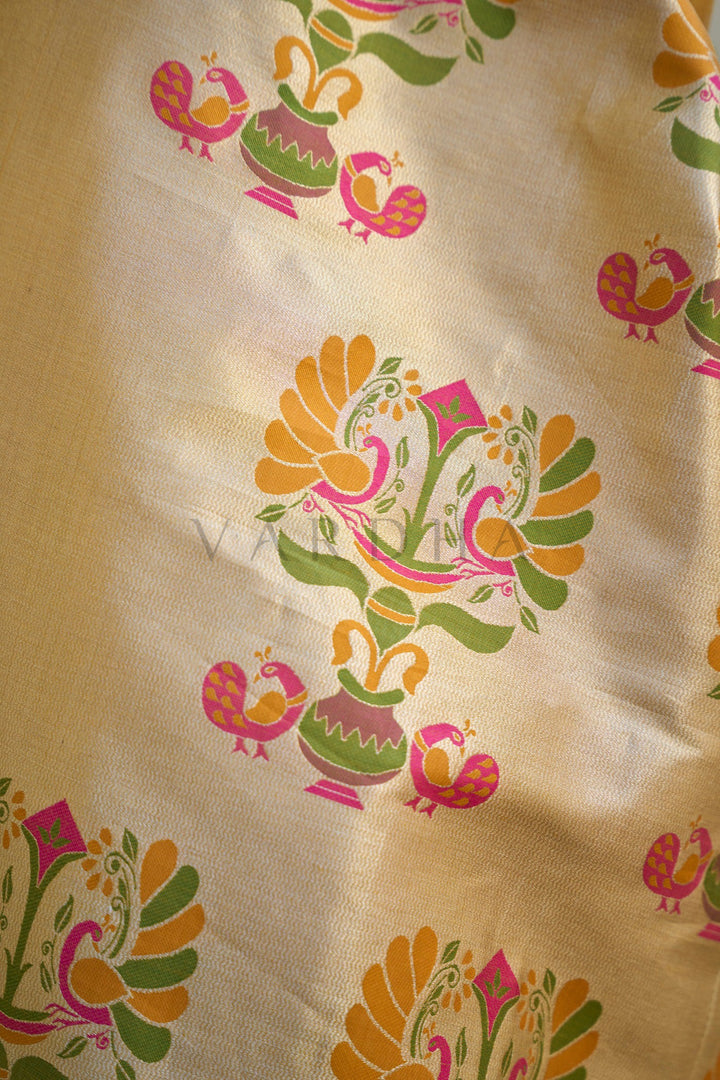 Decorative fabric with colorful peacock patterns on a beige background Close-up macro detail of the saree&