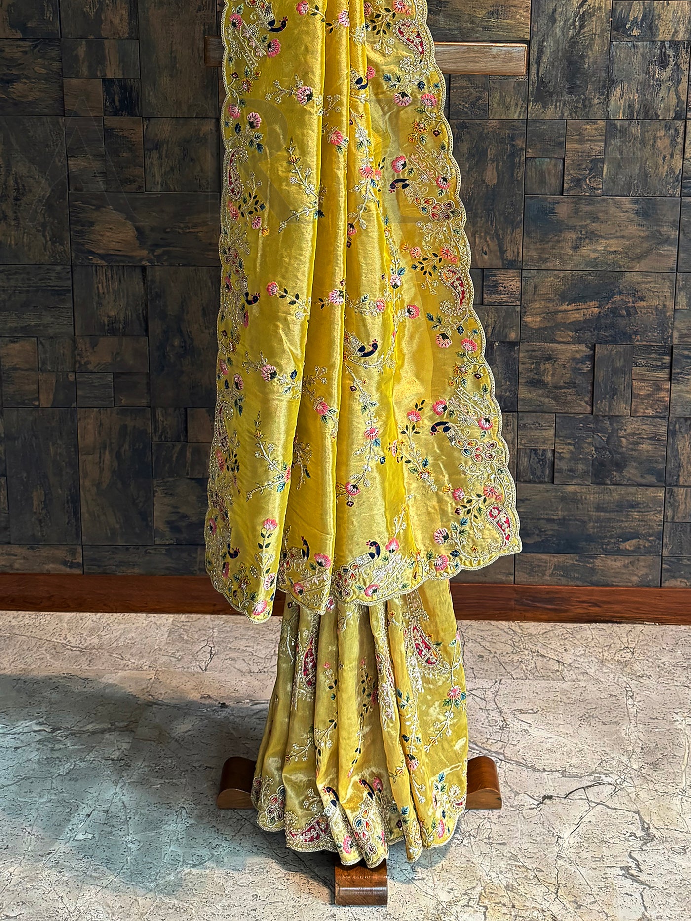 Traditional mustard tissue silk saree with scalloped edge border and intricate embroidery, ideal for weddings.