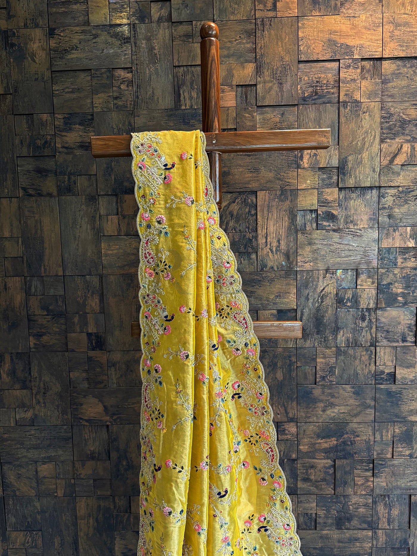 Mustard tissue silk saree with bird embroidery, zari highlights, and resham floral motifs for festive styling.