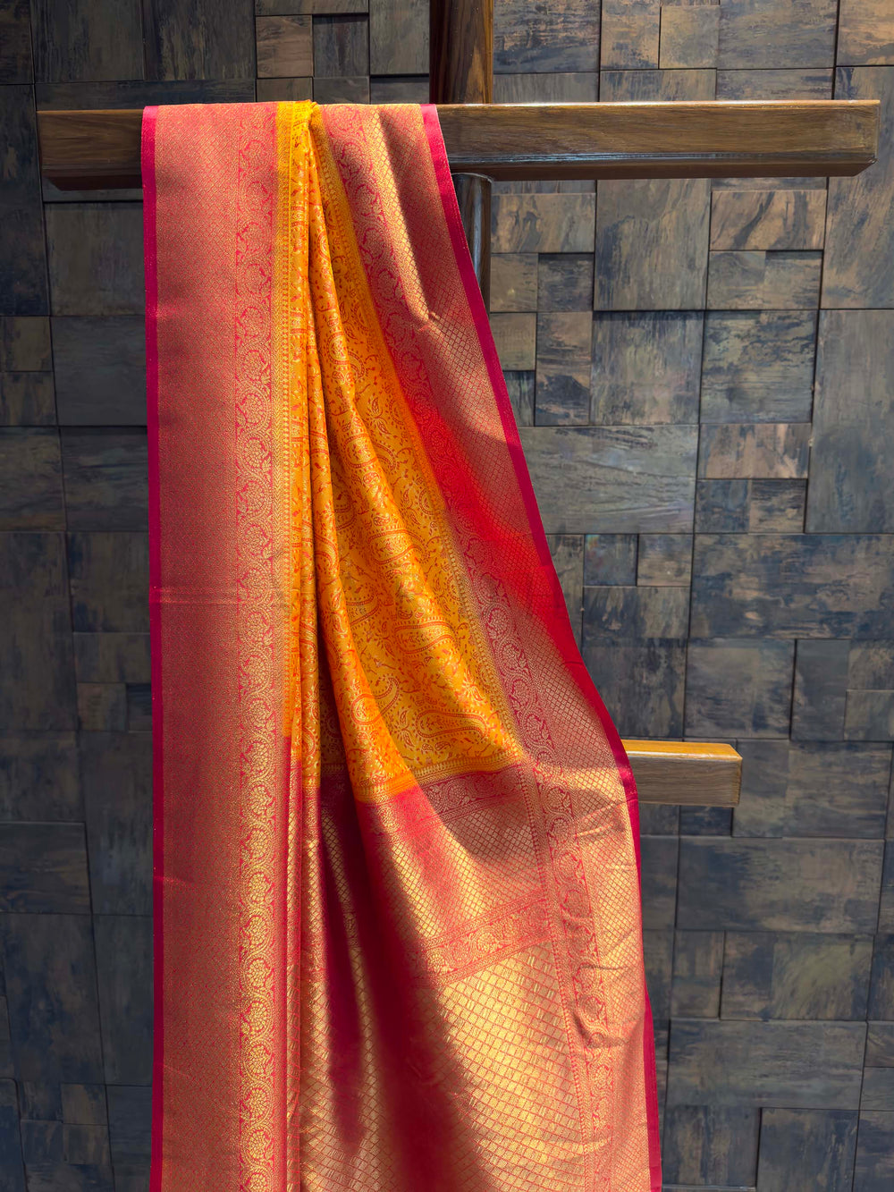Close-up of the sunset orange satin body showing pink woven paisley motifs.