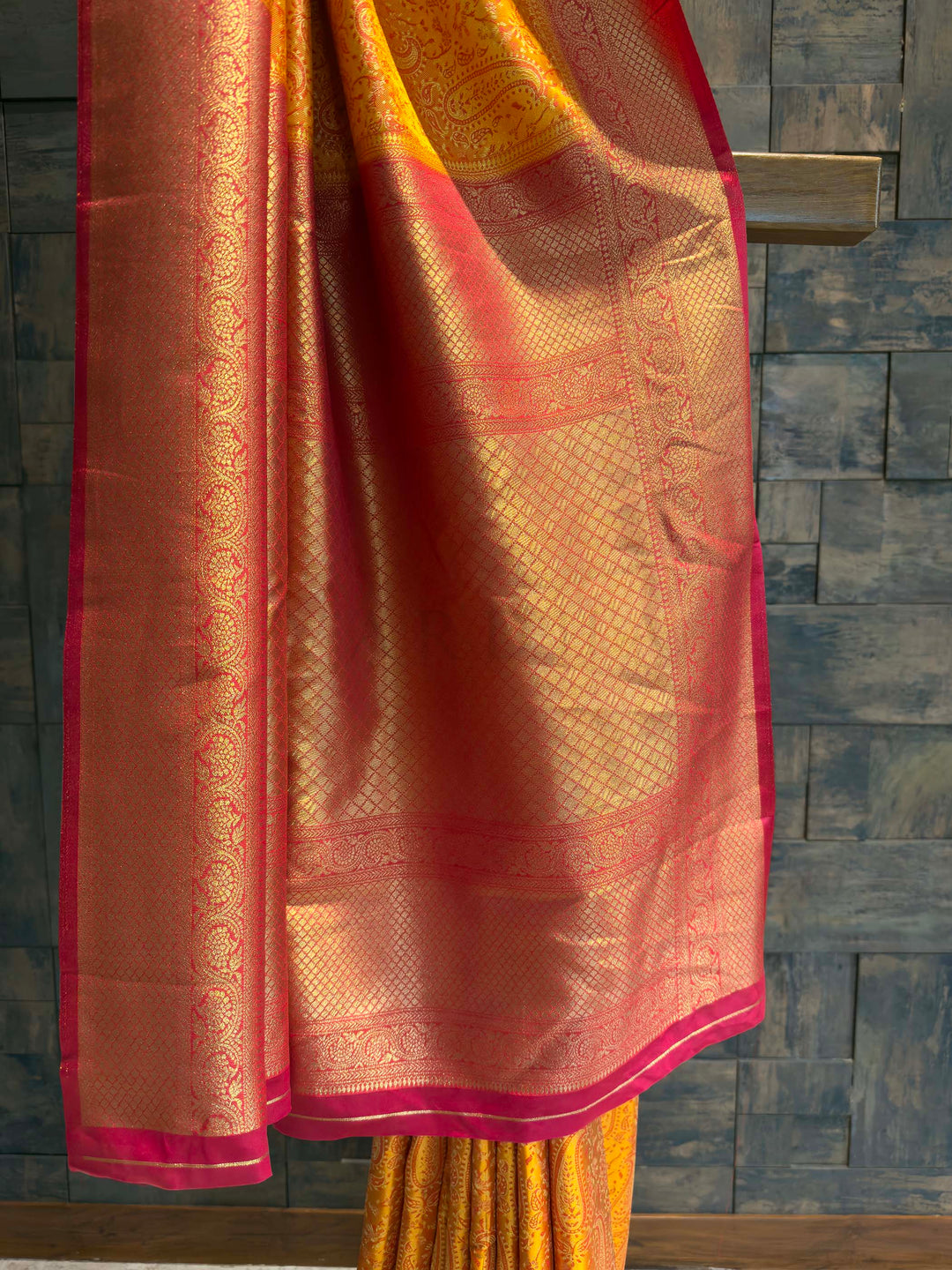 Detail shot of the Hot Pink Gold Zari border contrasting with the yellow body.