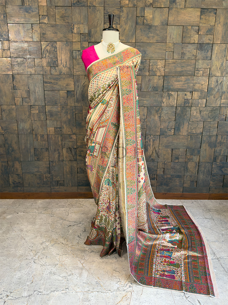 Saree with intricate patterns on a mannequin against a wooden paneled wall. Full-length view of an elegant off-white and cream designer silk saree draped on a mannequin, featuring a contrasting bright pink blouse and intricate multi-colored Meenakari weaving with traditional Indian motifs. Perfect for bridal trousseau and festive wear.