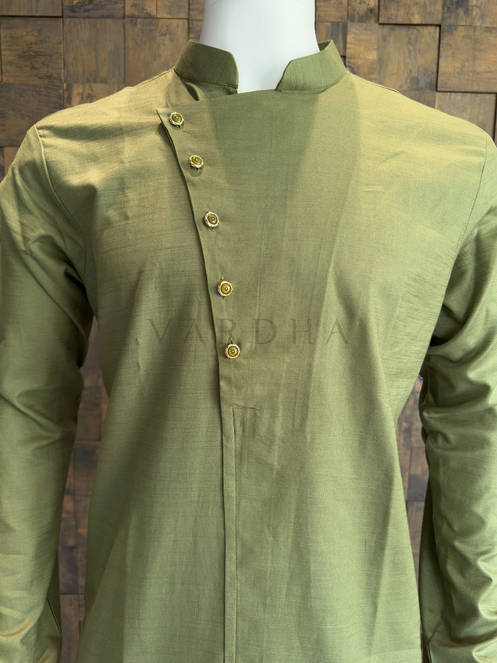 Green kurta on a mannequin against a wooden paneled wall Detailed view of the intricate gold-toned designer buttons on the angled placket of the green kurta.