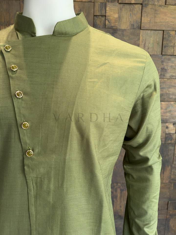 Green kurta with buttons on a wooden background, featuring the brand &