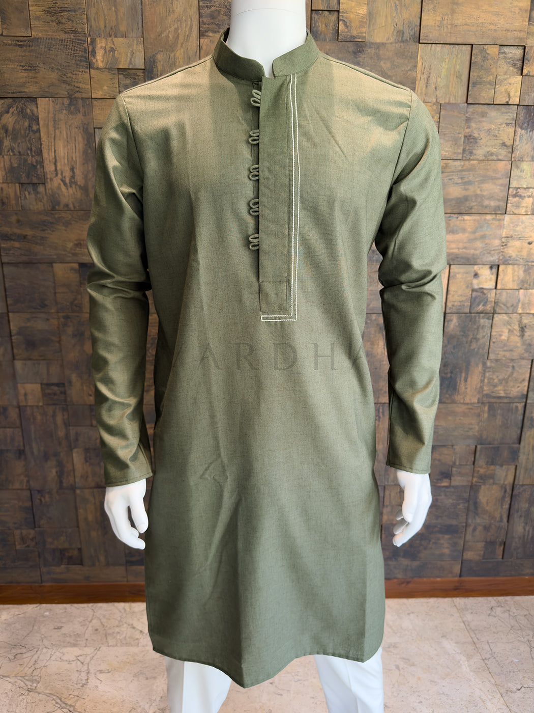Close-up of the olive green kurta showing the asymmetrical stitched placket and mandarin collar.