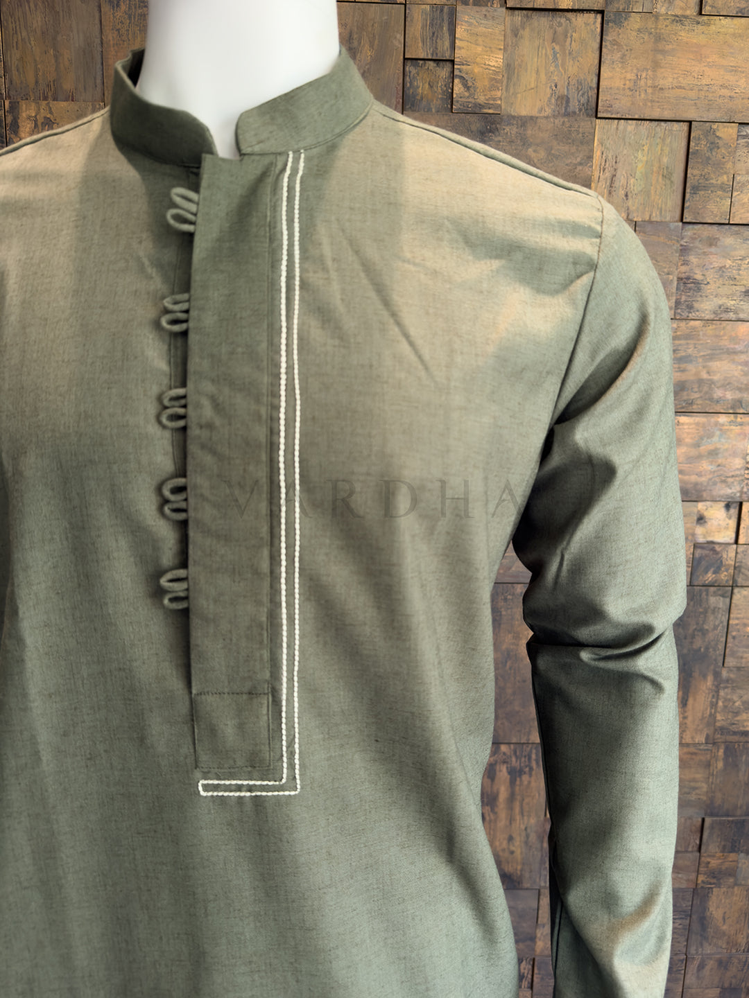 Close-up of the full sleeve and subtle slub texture on the olive green cotton kurta.