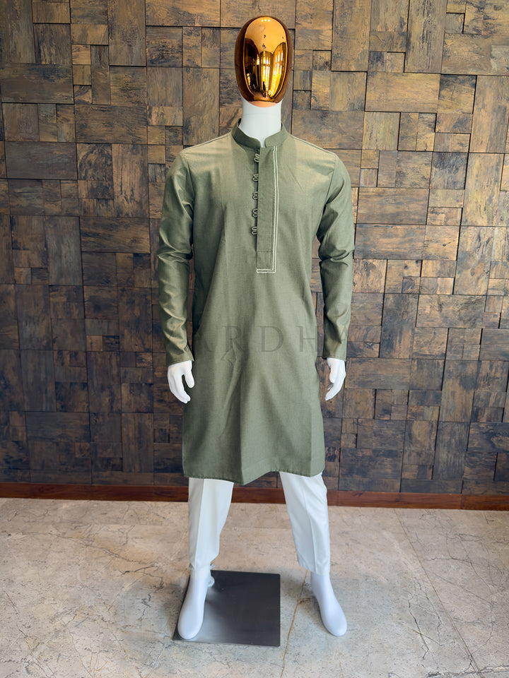 Front view of a man wearing an olive green asymmetrical cotton kurta with white pyjama.