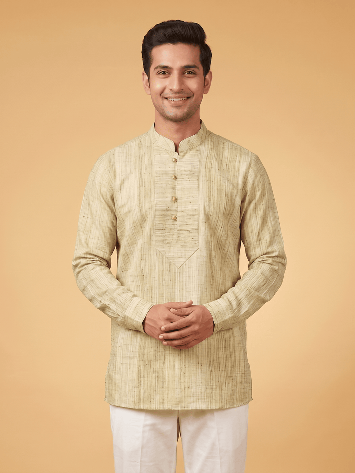 A man wearing a light beige textured kurta with a mandarin collar and white trousers, standing against a solid warm beige background. Back view of a man showcasing the fit of an olive green textured cotton short kurta paired with white trousers.