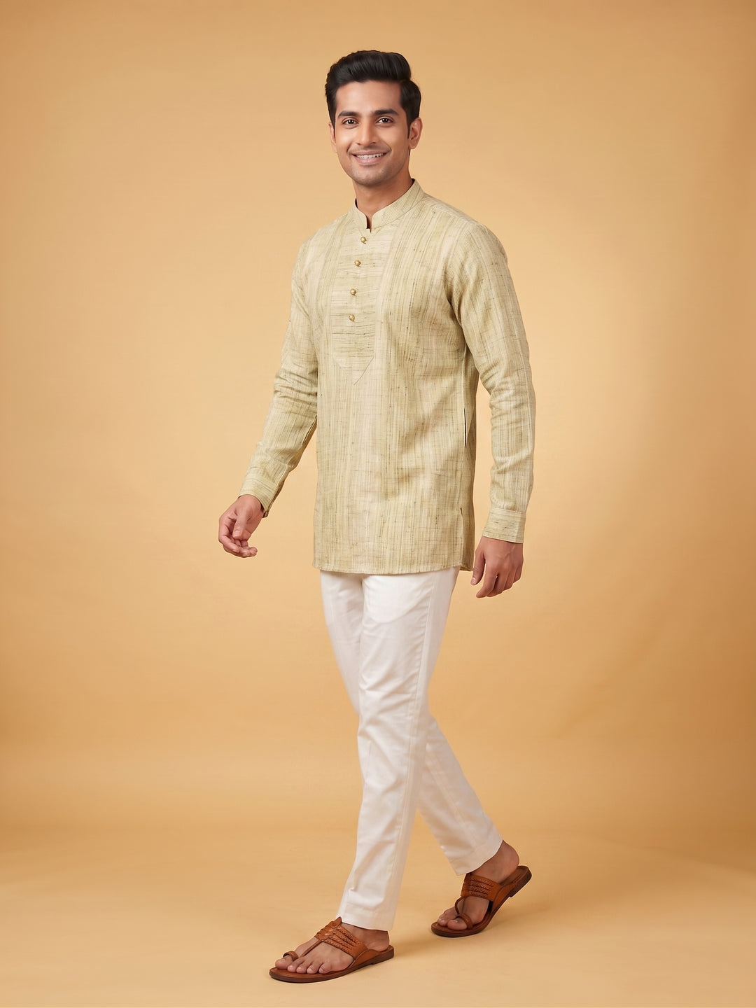 A man modeling a light beige textured kurta with a mandarin collar and white trousers, standing against a solid warm beige studio background. A man standing in an olive green textured cotton short kurta with a structured placket, view showcasing the relaxed silhouette.