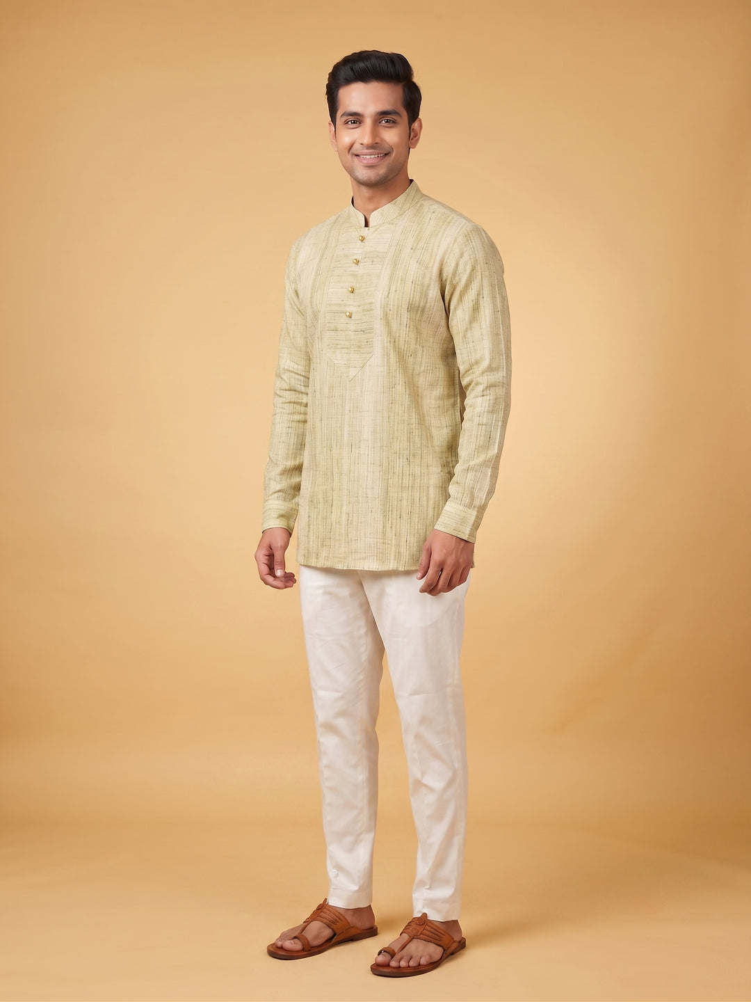 A man modeling a light beige textured kurta with a mandarin collar and white trousers, standing against a solid warm beige studio background. Close-up of a man wearing an olive green textured cotton short kurta, highlighting the structured placket and intricate fabric texture.