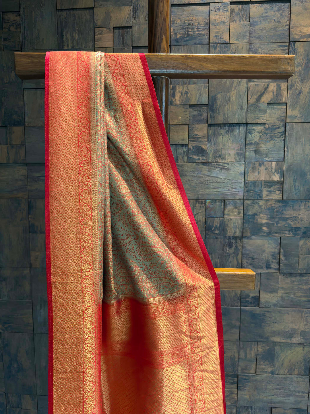 Close-up of the bronze-grey satin body showing teal woven paisley motifs.