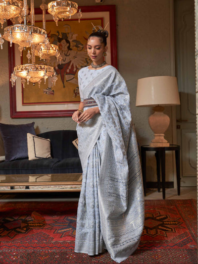 Pastel Grey Kashmiri Modal Silk Saree featuring Intricate Floral Weaving and Handloom Craftsmanship, offering a Luxurious Drape for Elegant Occasions.

