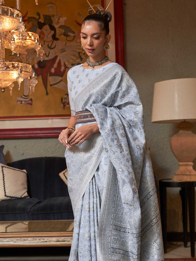 Elegant Pastel Grey Floral Woven Saree in Kashmiri Modal Silk, showcasing Traditional Handloom Techniques and Exquisite Floral Patterns, perfect for Cultural Celebrations.

