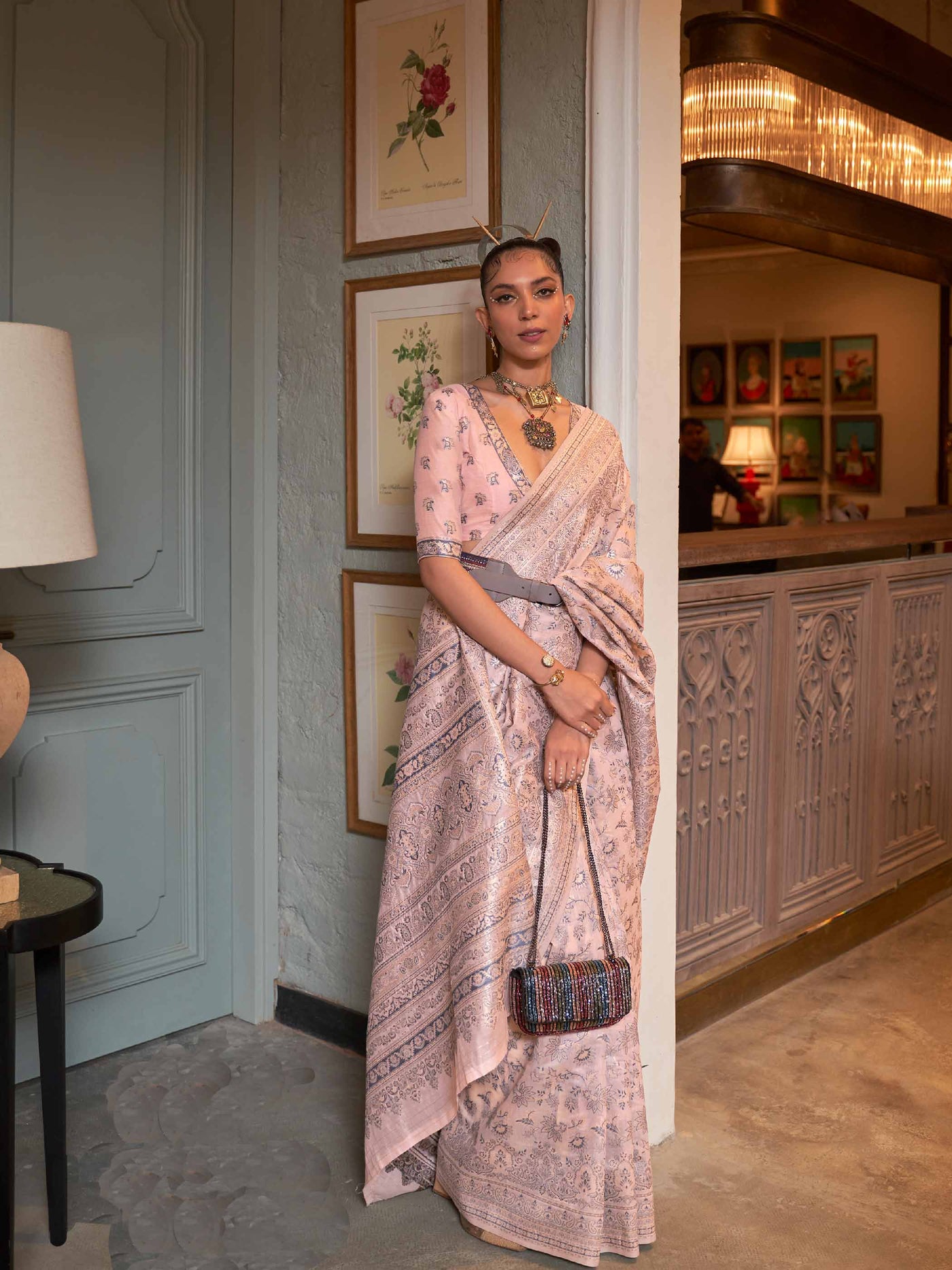 Peach Kashmiri Modal Silk Saree featuring Intricate Floral Weaving and Handloom Craftsmanship, offering a Luxurious Drape for Elegant Occasions.

