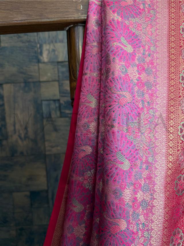 Pink woven saree in Kalamkari art style with luxury drape and detailed contrast pallu design. Heirloom-inspired pink art silk saree with multi-hued Kalamkari design and floral zari edge.

