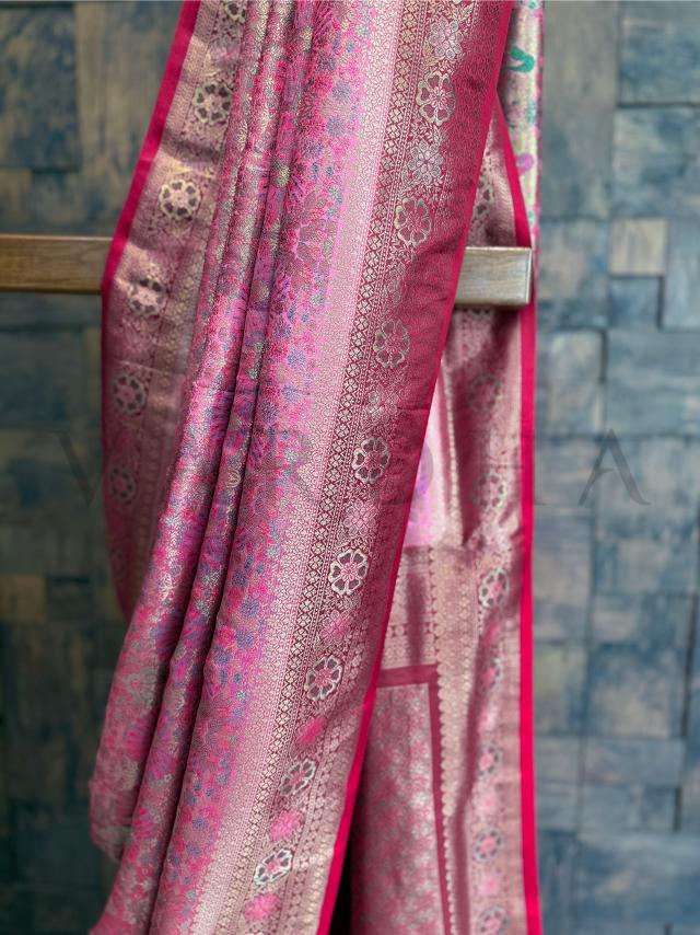 Elegant pink saree in art silk with floral zari borders and detailed Kalamkari work throughout. Peacock-themed pink cream Kalamkari saree in art silk, finished with vibrant woven borders.
