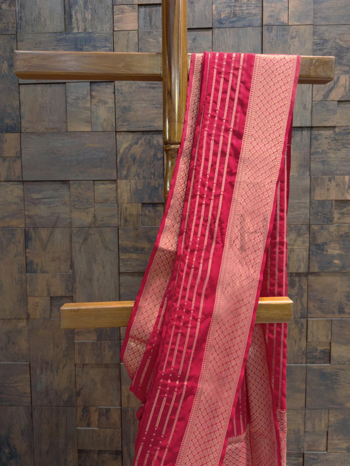 Full view of georgette saree highlighting bandhani-inspired golden lines and light-reflecting featherweight texture Diamond border woven in gold zari with delicate featherlike drape and pleats flowing down to hem
