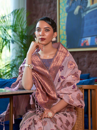Elegant Pink Organza Silk Saree adorned with Intricate Zari Weaving and a Heavy Border, offering a Luxurious Drape—ideal for those seeking Authentic Ethnic Wear with a Contemporary Touch. 
