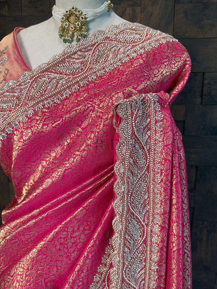Pink saree with intricate silver embroidery on a wooden background. Designer Heavily Embroidered Pink Blouse Piece paired with Kanjivaram Saree