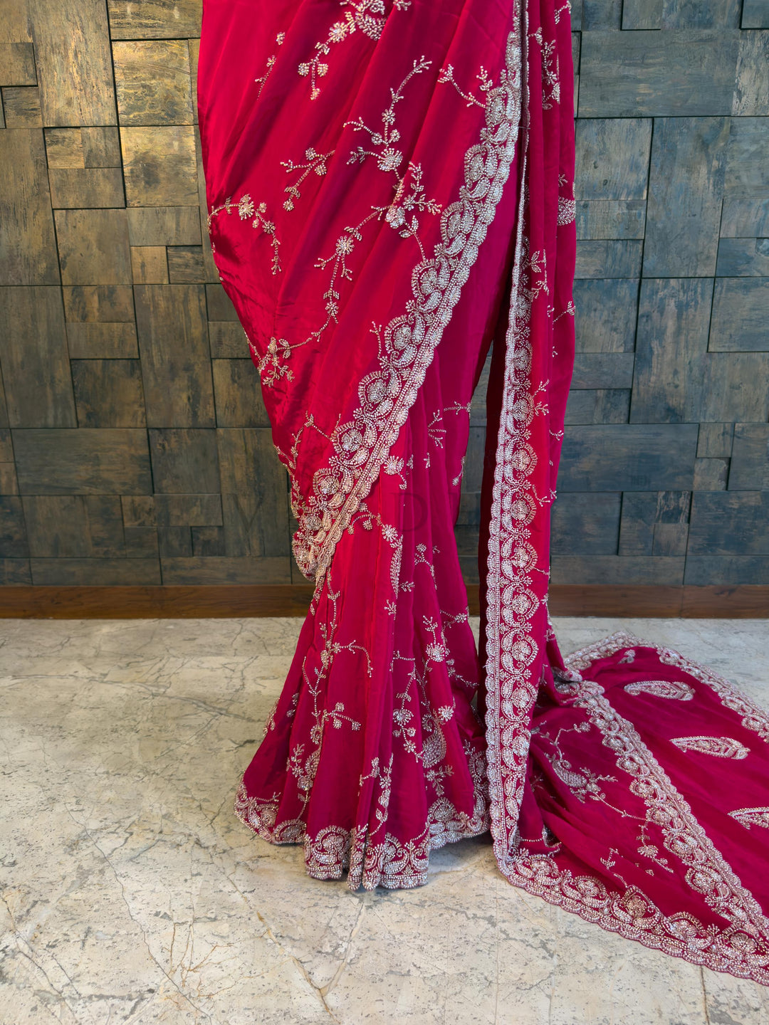Fluid Drape of Satin Crepe Saree in Vibrant Pink Close-up view of the House of Vardha Pink Satin Crepe Saree highlighting the detailed sparkling floral embroidery and delicate scalloped edges. We offer Ready to wear, Pre drape service, Saree Add on, Custom Stitched Blouse, Fall and Edging, Gift Packaging at Complimentary Price!