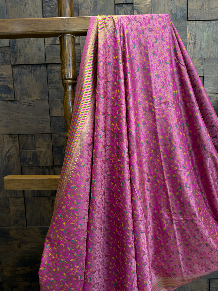Tanchoi weave close-up showing vibrant parrot motifs on pink satin silk saree, ideal for Haldi and pooja functions