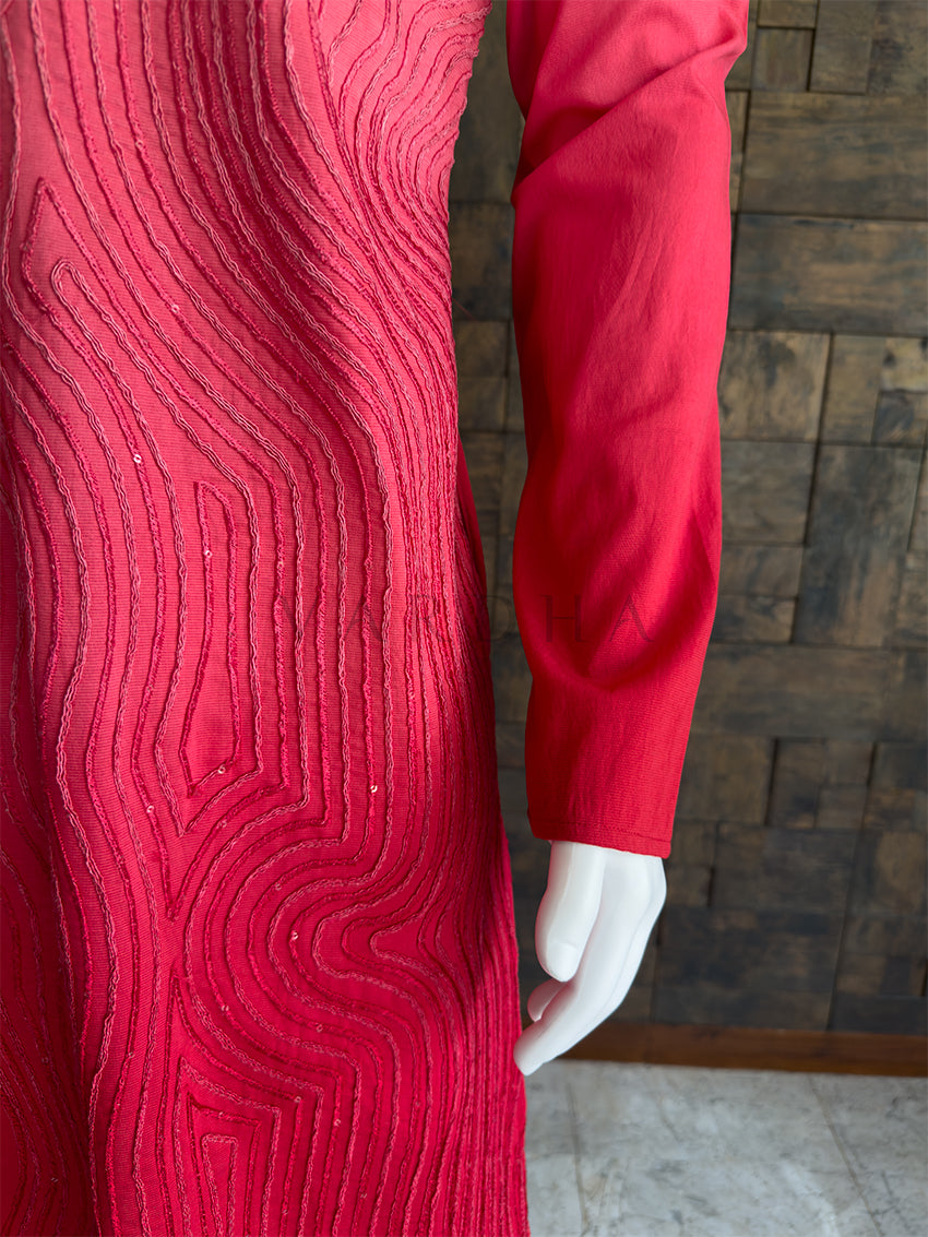 pink textured dress on a mannequin against a wooden paneled wall. Close-up of the kurta sleeve showing the detailed, continuous swirling cord pattern on the premium pink viscose fabric.