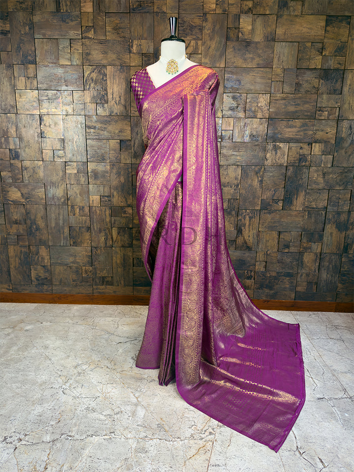 Full-length view of a Purple Kanjivaram art silk saree draped elegantly on a mannequin, showcasing heavy golden floral zari work throughout the body and borders
