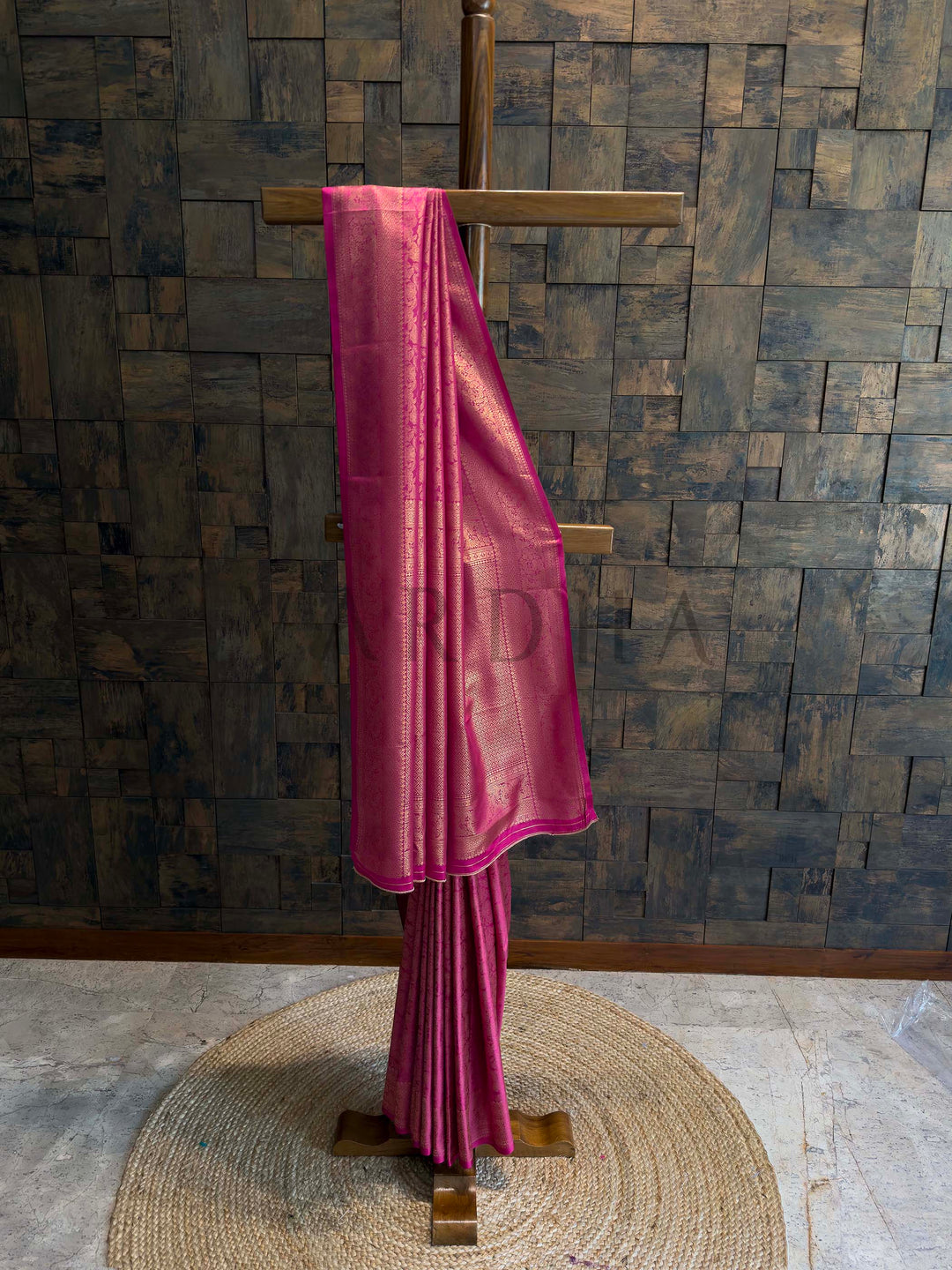 Rani pink Kanjivaram art silk saree on stand with golden zari floral jaal and geometric brocade borders, rich pallu and crisp pleats, traditional festive saree. House of Vardha designer Rani Pink Kanjivaram Silk Saree featuring traditional Gold Zari buttis across the body and a heavy, decorative pallu. We offer Ready to wear, Pre drape service, Saree Add on, Custom Stitched Blouse, Fall and Edging, Gift Packaging at Complimentary Price!