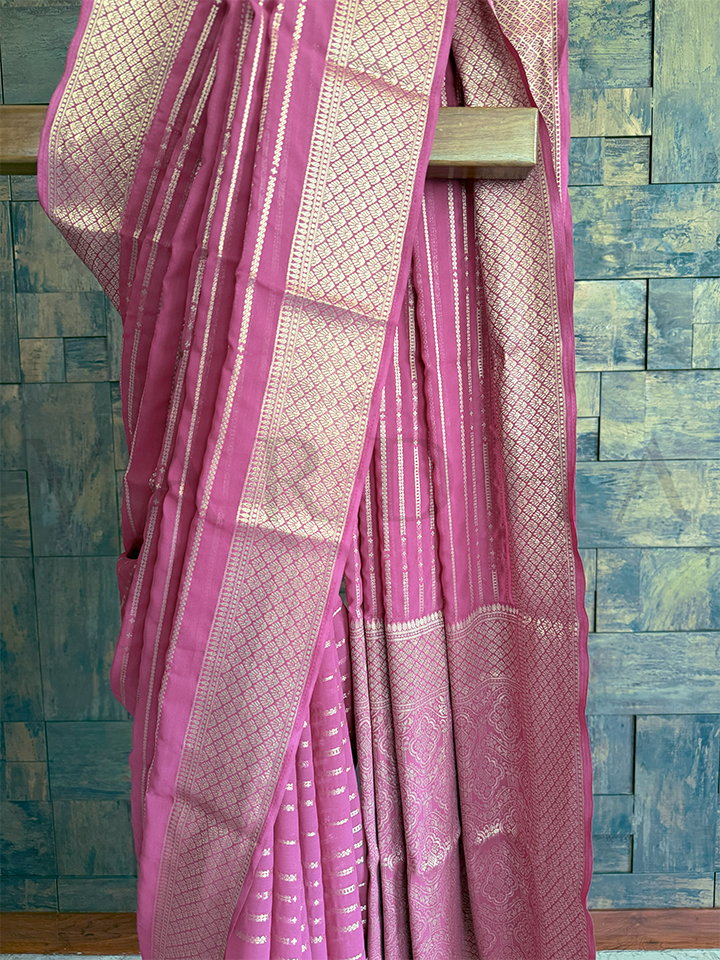 Zari striped rose pink georgette saree with intricate threadwork, diamond jaal, and light paisley accents in pallu