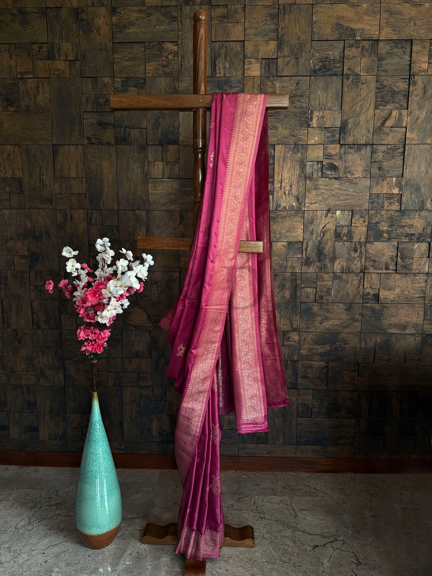 Rose pink satin saree with antique gold zari border and minimal floral motifs – elegant ethnic wear.

Glossy satin silk saree in blush pink with intricate woven border and subtle floral patterns.