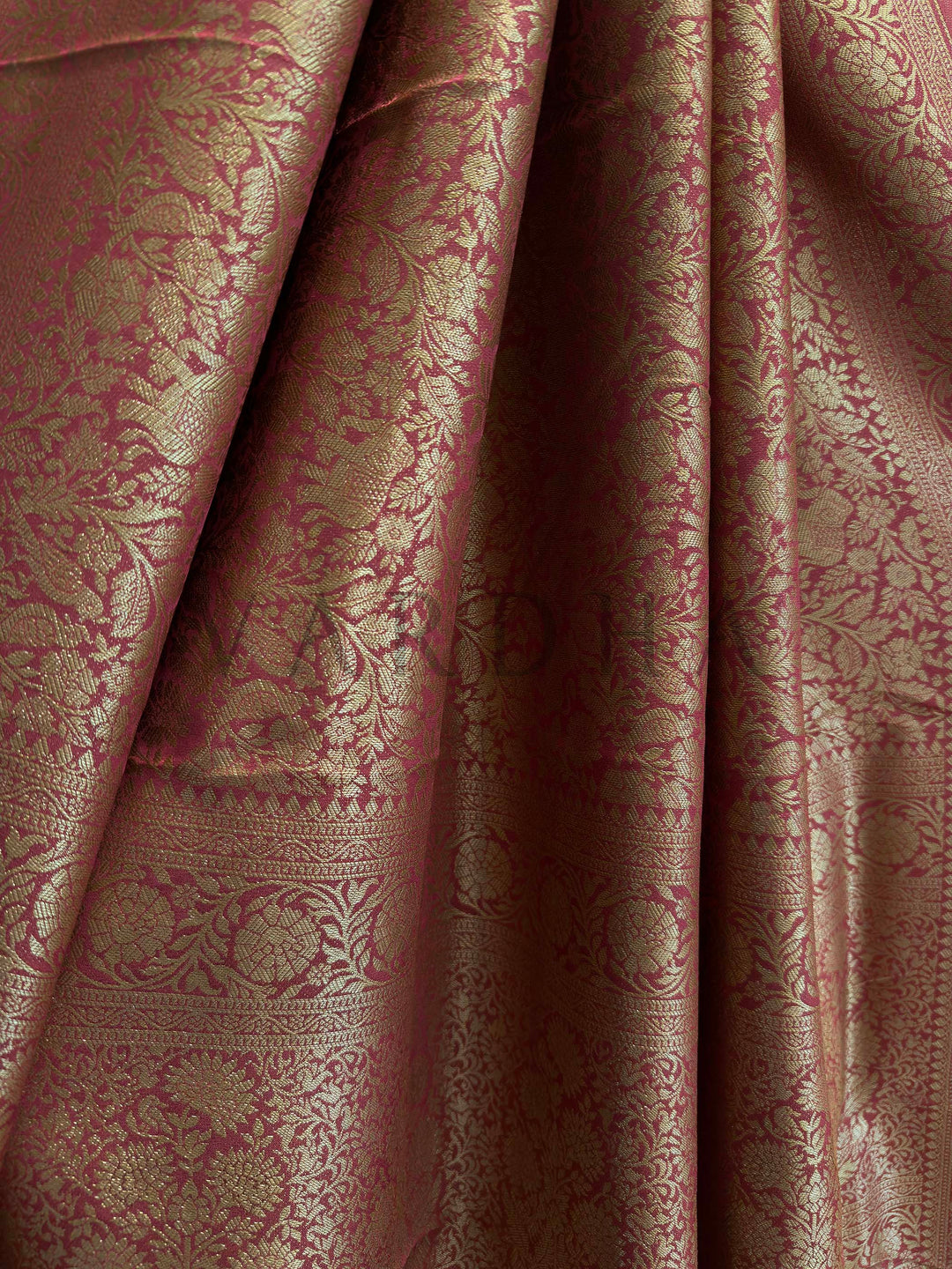 Pallu of rust red Mysore silk saree featuring woven elephant and bird motifs in zari.