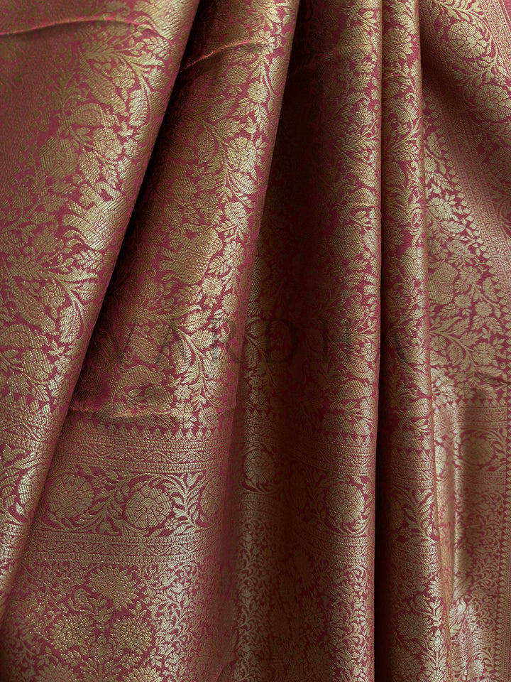 Pallu of rust red Mysore silk saree featuring woven elephant and bird motifs in zari.