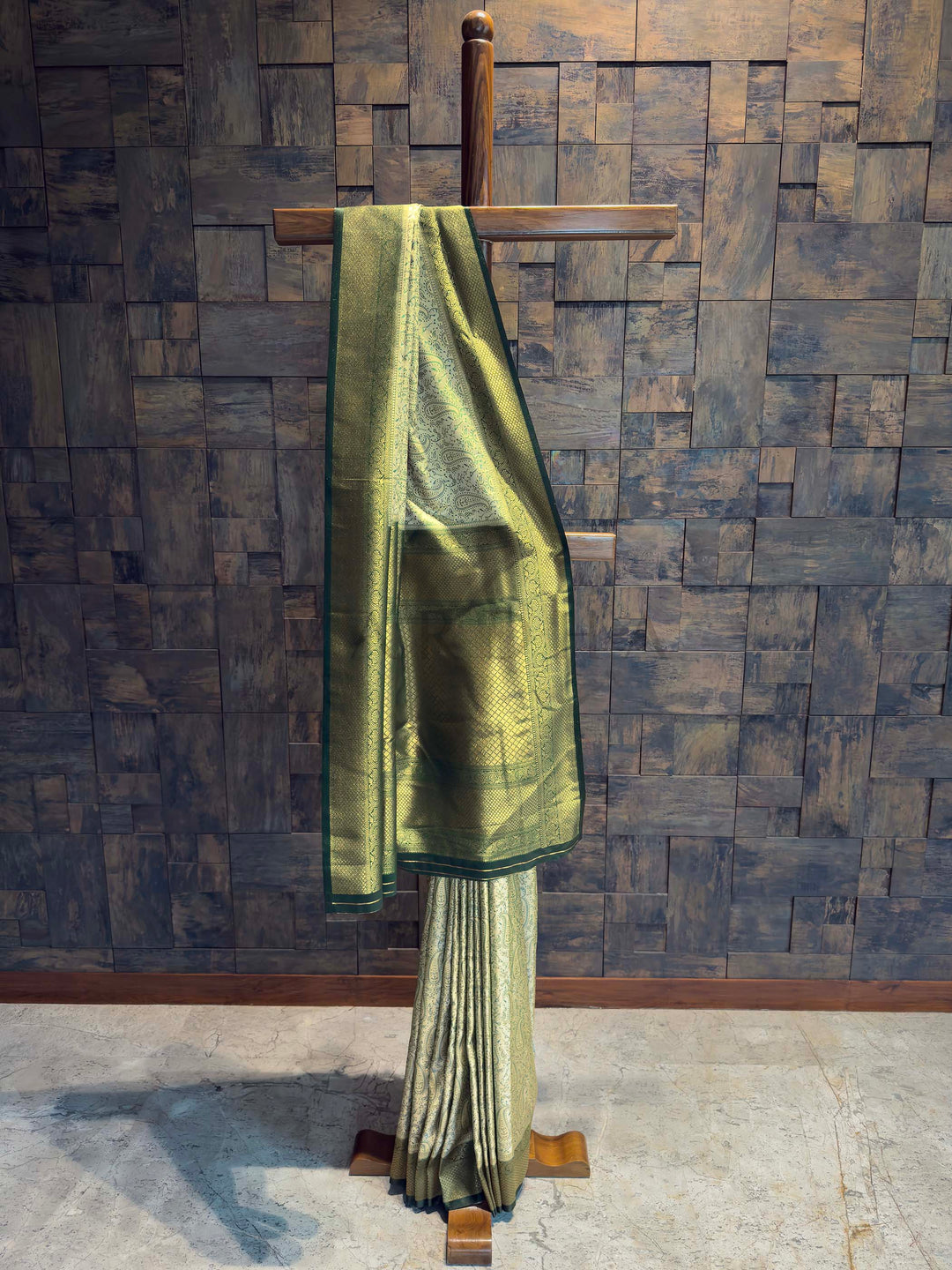 Full drape view of Sage Green Tanchoi Satin Silk saree with Dark Green border on mannequin.