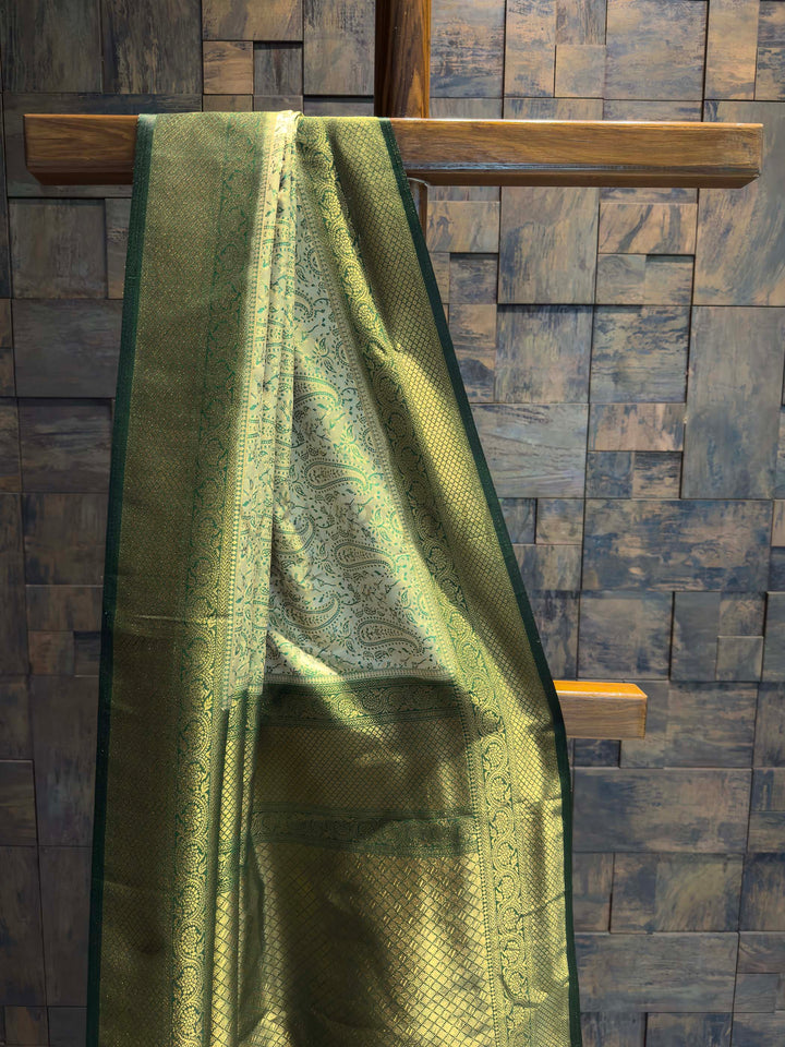 Close-up of the pastel green satin body showing woven paisley motifs.