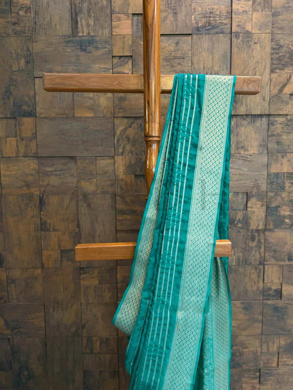 Close-up of border and pallu revealing detailed zari pattern on teal georgette fabric with lightweight drape. - Full front drape view of teal saree with horizontal zari stripes and soft gold border ideal for day functions