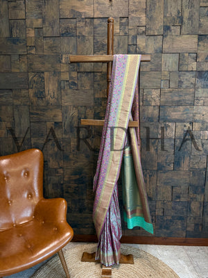 Sea green Tanchoi saree displayed with golden striped zari border, thread-woven motifs, and contrast pallu for festive occasions