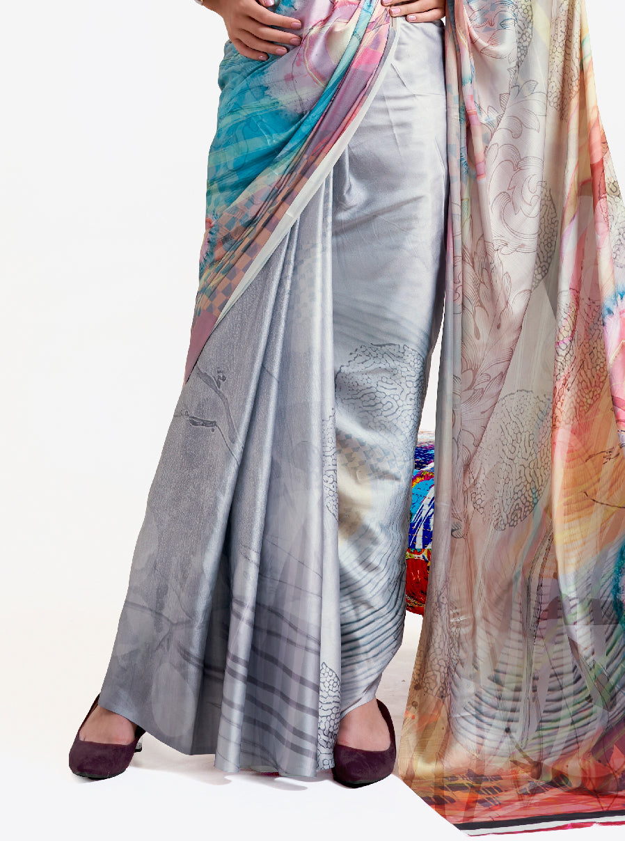 Designer silver grey-blue crepe saree featuring digital floral prints and Bollywood-style drape, ideal for celebrations.