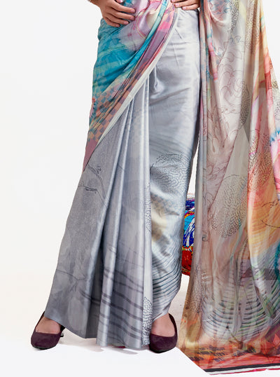 Designer silver grey-blue crepe saree featuring digital floral prints and Bollywood-style drape, ideal for celebrations.