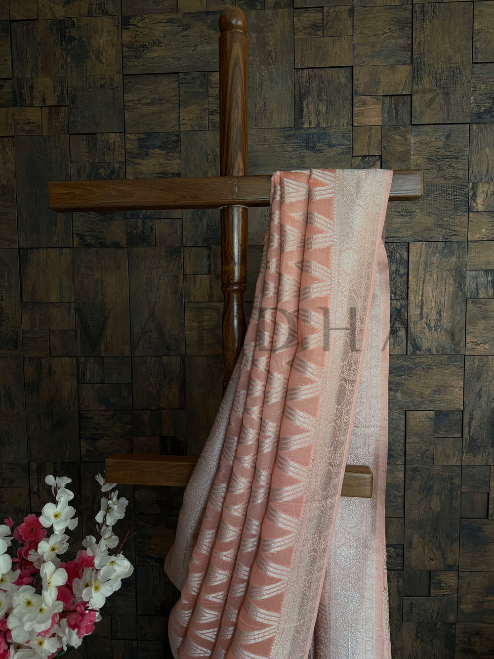 Detailed view of soft orange saree with silver shimmer threadwork and subtle embroidery accents