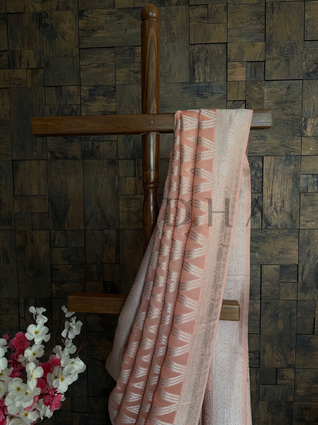 Detailed view of soft orange saree with silver shimmer threadwork and subtle embroidery accents