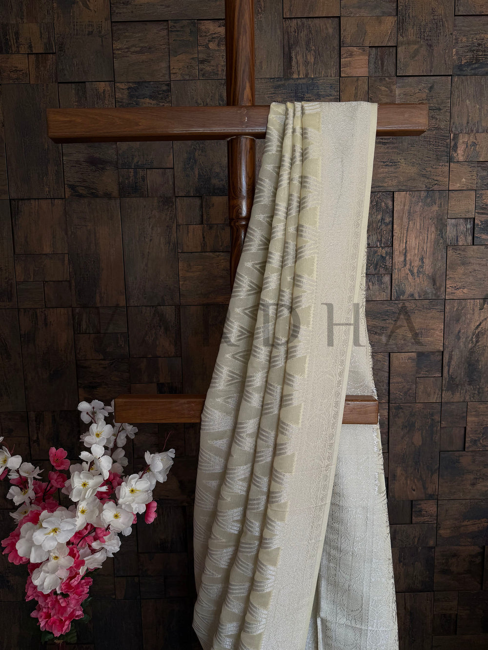 Detailed chevron weave with subtle embroidery and sequin-style shimmer threadwork on yellow georgette saree