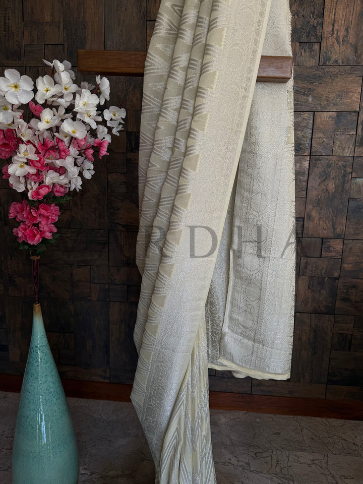 Lightweight yellow georgette saree with soft drape, chevron design, and delicate shimmer embellishments