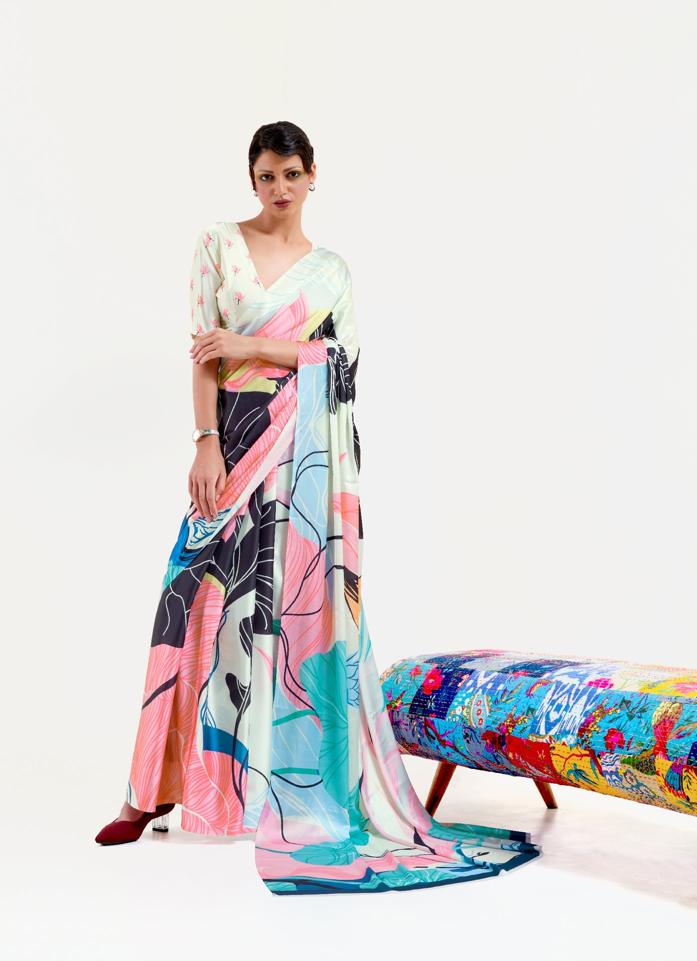 Elegant black and pastel green-white crepe saree featuring digital floral prints and Bollywood-style drape, ideal for cultural celebrations.