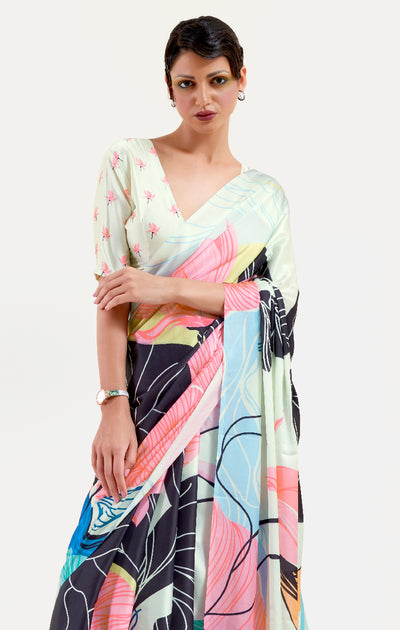 Chic black and pastel green-white crepe saree adorned with digital floral designs and Bollywood drape, suitable for special events.