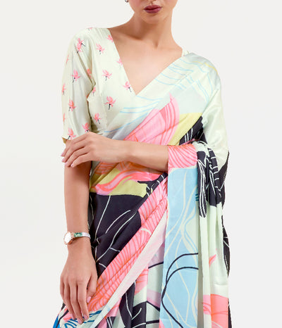 Stylish black and pastel green-white crepe saree showcasing digital floral motifs and Bollywood-style drape, ideal for cultural festivities.