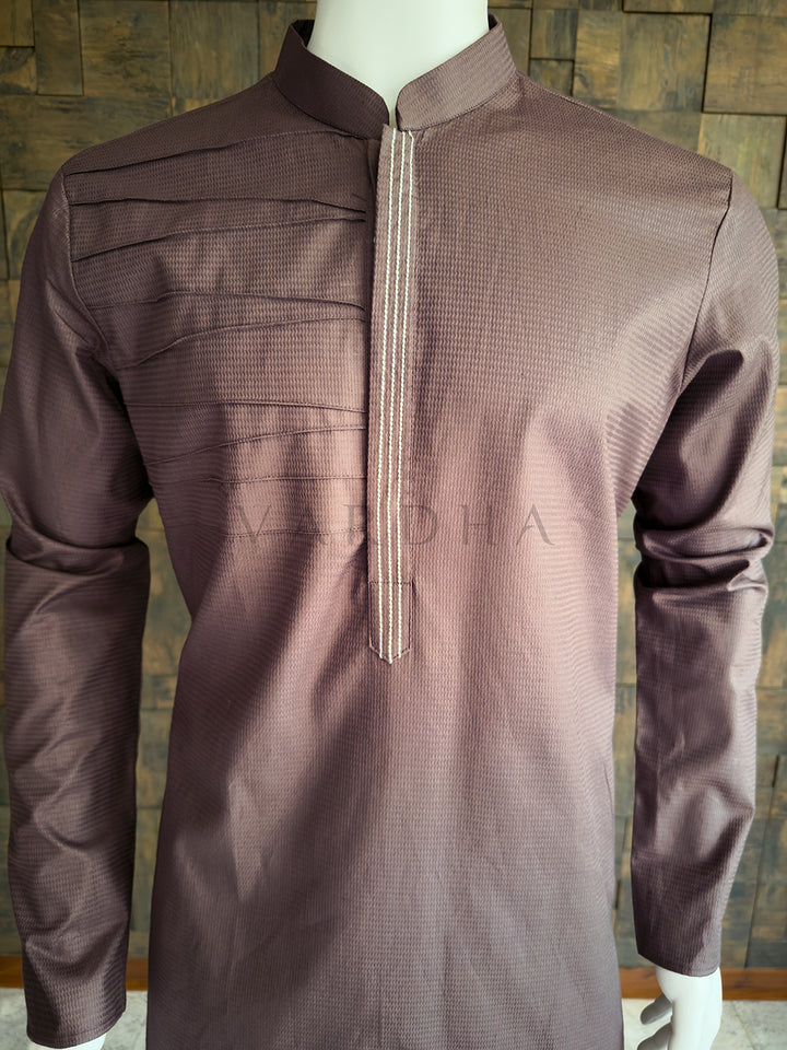 Brown kurta on a mannequin against a wooden paneled wall Detailed chest view highlighting the crisp mandarin collar, horizontal pintucks, and embroidered concealed placket on the premium taupe brown cotton designer kurta for men.